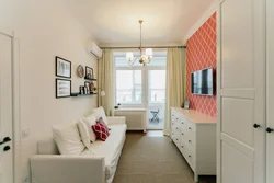 Interior of a narrow living room with one window