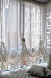 Tulle up to the window sill in a modern bedroom photo