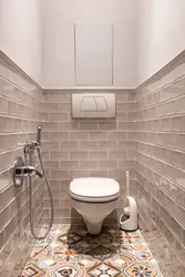 Photo of a toilet in an apartment tile design