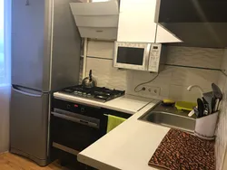Kitchen design in an apartment with a gas stove and refrigerator