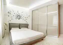 Photo of a bedroom in an apartment with a wardrobe