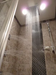 Photo of a bathtub with a rain shower