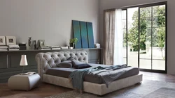 Bedroom design with a bed with a soft headboard