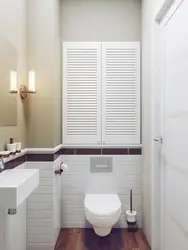 Louvered doors in the bathroom interior