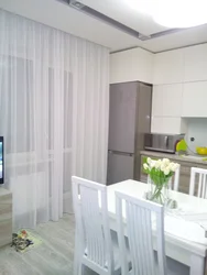 White curtains in the kitchen in the interior photo