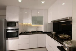 Black Appliances In The Interior Of A Light Kitchen