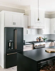 Black appliances in the interior of a light kitchen