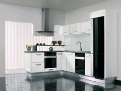 Black Appliances In The Interior Of A Light Kitchen