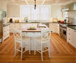 White Kitchen And Wooden Table Photo