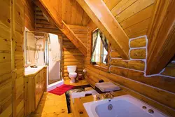 Toilet with bathtub in a wooden house photo design