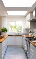 Kitchen design in a modern corner style with a window in the house