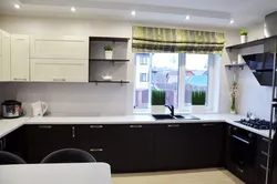 Kitchen design in a modern corner style with a window in the house