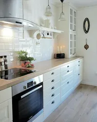 Photo of a kitchen without upper cabinets in style