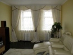 Curtains for two windows with a wall photo in a modern living room