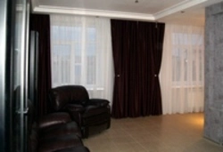 Curtains For Two Windows With A Wall Photo In A Modern Living Room