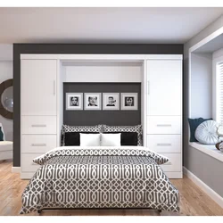 Bed between wardrobes in bedroom design