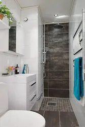 Bathroom with tiled shower and washing machine photo