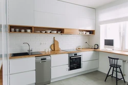 White kitchen with wooden countertops, real photos