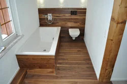 In the bathroom there are laminate tiles on the floor photo