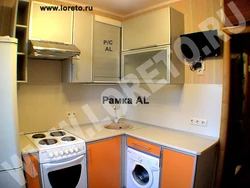 Kitchen in Khrushchev with a water heater and a washing machine photo