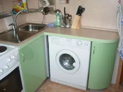 Kitchen in Khrushchev with a water heater and a washing machine photo