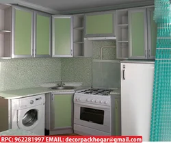 Kitchen in Khrushchev with a water heater and a washing machine photo