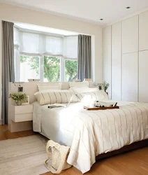 How to position the bed in the bedroom relative to the window photo