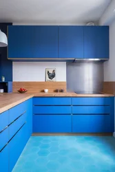 Blue kitchen with wooden countertops in the interior photo