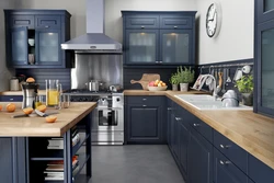 Blue kitchen with wooden countertops in the interior photo