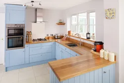 Blue Kitchen With Wooden Countertops In The Interior Photo