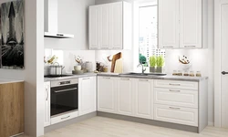 Photo of a white kitchen with wooden walls