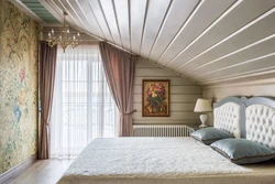 Bedroom in the attic of a wooden house with a sloping ceiling photo