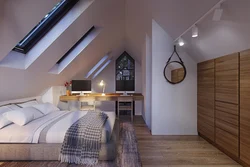 Bedroom in the attic of a wooden house with a sloping ceiling photo