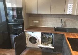 Kitchen with refrigerator and washing machine photo