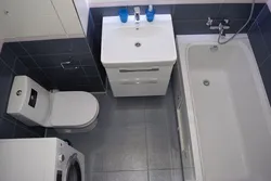 Photo of a bathroom with toilet and washing machine design