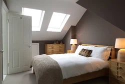 Bedroom design in the attic with a sloping ceiling