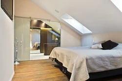 Bedroom design in the attic with a sloping ceiling