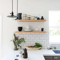 Shelves on the wall in the kitchen above the table photo