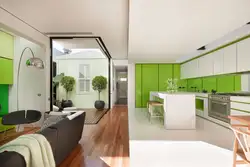 Green Kitchen In The Interior With Living Room Design