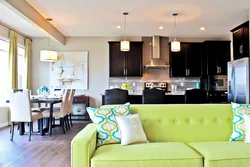 Green kitchen in the interior with living room design