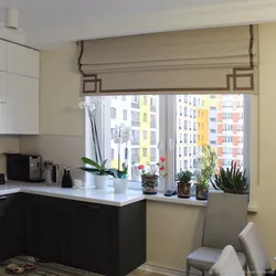 Roman blinds in the kitchen interior with tulle