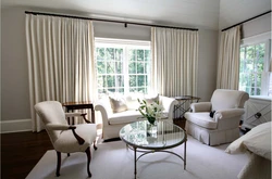 Curtains under gray walls in the living room interior