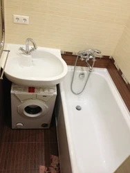 Bath with washbasin and washing machine photo