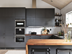 Photo of a gray kitchen combined with white