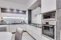 Photo of a gray kitchen combined with white