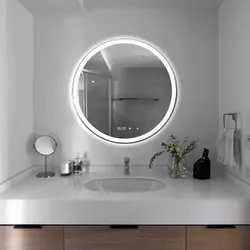 Round mirror in the bathroom interior