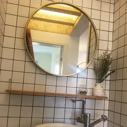 Round mirror in the bathroom interior