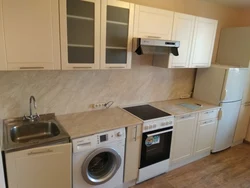 Kitchen With Washing Machine And Stove Photo