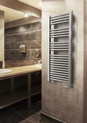 Heated towel rail in the bathroom interior