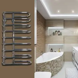 Heated towel rail in the bathroom interior